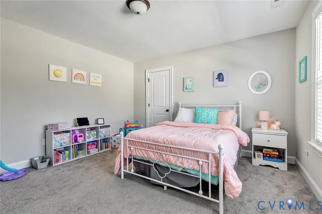 a bedroom with a bed and a desk