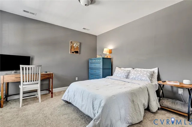 a bedroom with a bed and a chair