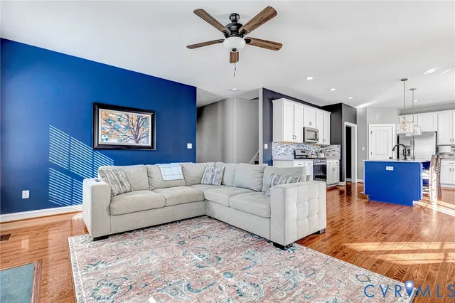 a living room with furniture and kitchen view