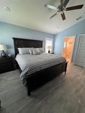 a large bathroom with a glass shower door and a bathtub