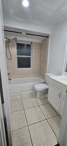 a view of washer and dryer with bathtub in bathroom