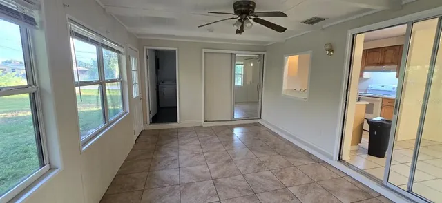 a view of a hallway to a livingroom with furniture