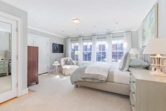 a bed room with furniture and a large window