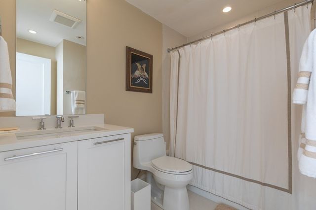 a bathroom with a toilet a sink and a mirror