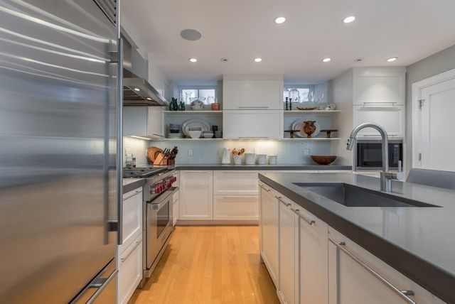 a kitchen with counter top space cabinets and stainless steel appliances