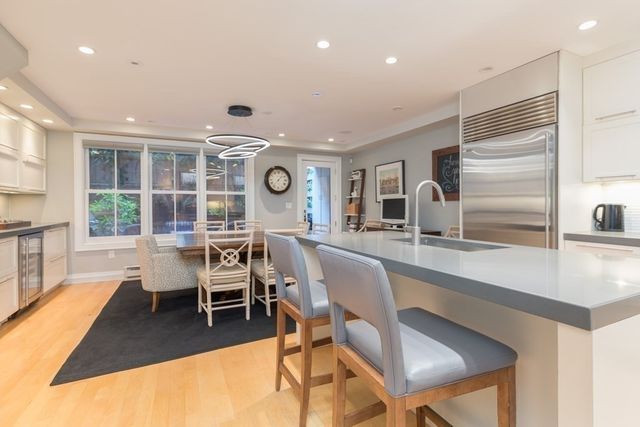 a living room with a large window and chairs