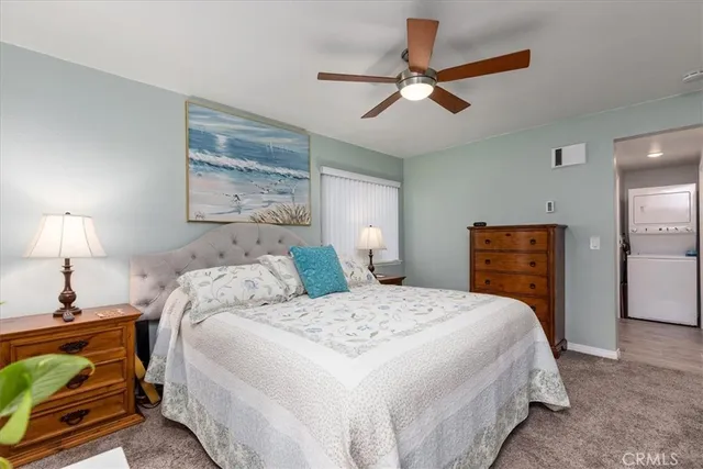 a bedroom with a bed and ceiling fan