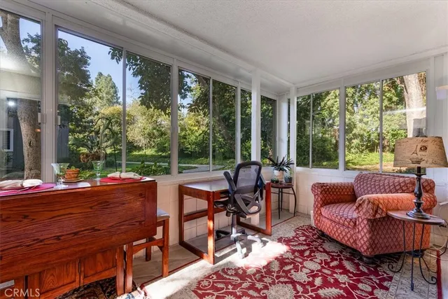 a living room with furniture and a floor to ceiling window