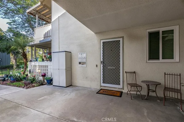 a view of a patio with table and chairs and potted plants