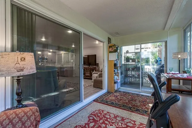 a bathroom with a glass door shower and a couch