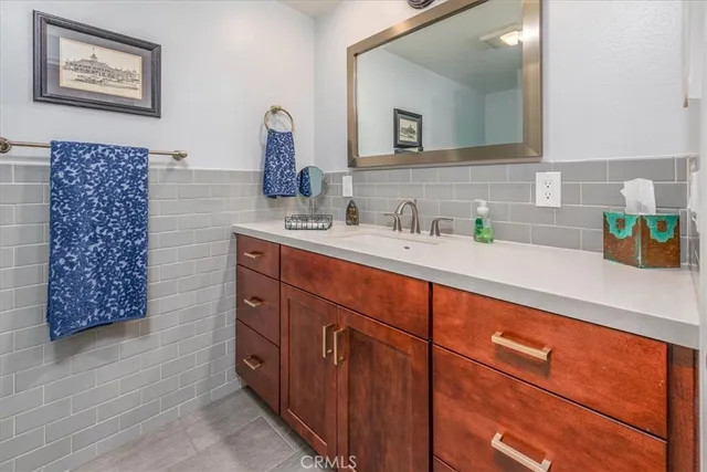 a bathroom with a sink a vanity and a mirror