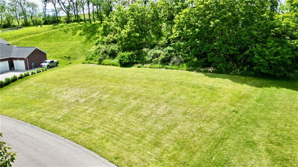 Lot #39 Sunrise Lane McDonald, PA 15057 - Photo 6 of 13 a view of a yard with a table and chair under an umbrella