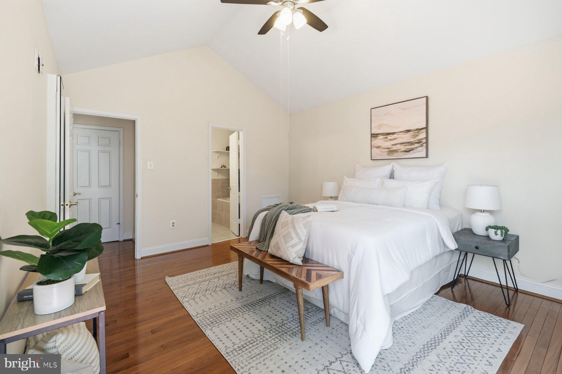 14215 Greenview Drive Laurel, MD 20708 - Photo 19 of 35 a bedroom with a bed table flowerpot and a potted plant