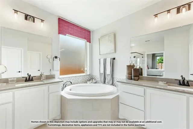 a en suite bathroom with a double vanity sink a mirror and a shower