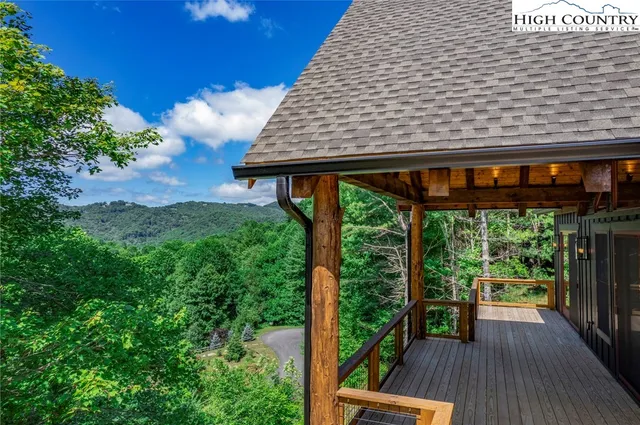 a backyard of a house with wooden floor and outdoor seating