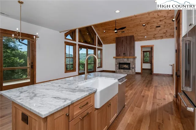 a view of kitchen island with granite countertop furniture and a fireplace