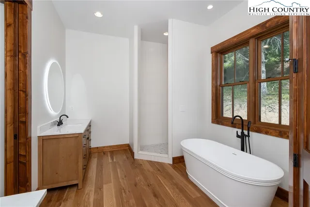 a bathroom with a sink a toilet and a large mirror