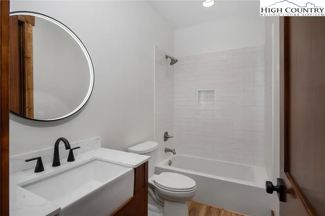 a bathroom with a sink toilet and a mirror