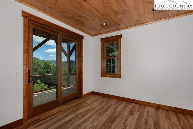 a view of room with window and wooden floor