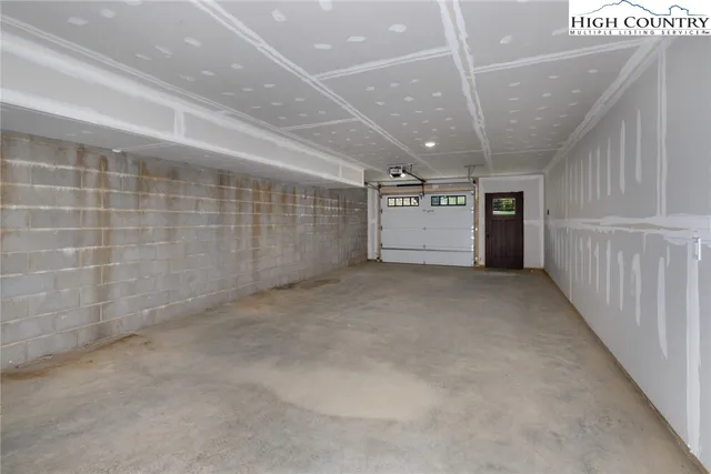 a view of a backyard with table and chairs potted plants and tree
