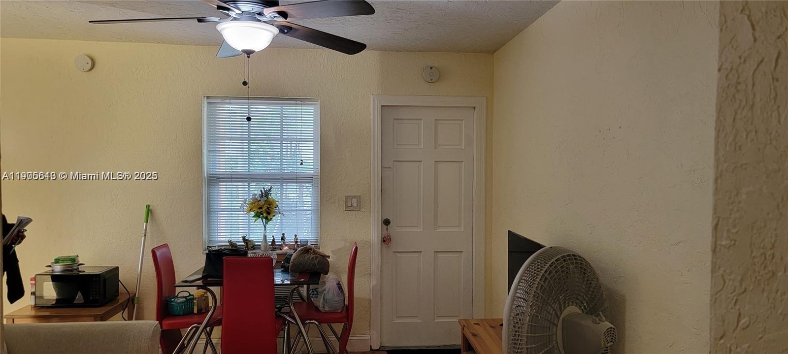 2441 Southwest 27th Avenue, Unit 1 Miami, FL 33145 - Photo 2 of 8 a view of a livingroom with furniture and chandelier