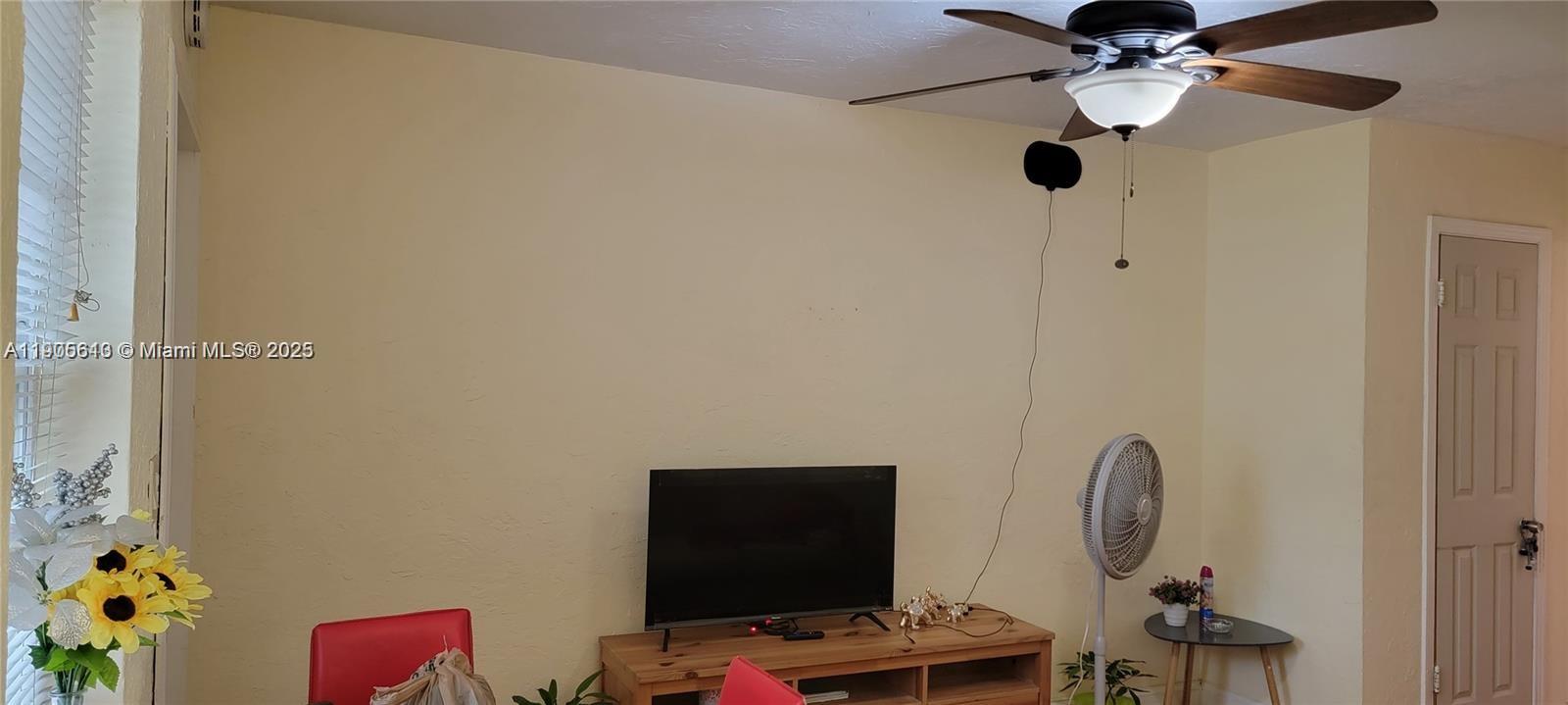 2441 Southwest 27th Avenue, Unit 1 Miami, FL 33145 - Photo 3 of 8 a bedroom with a bed and a chandelier