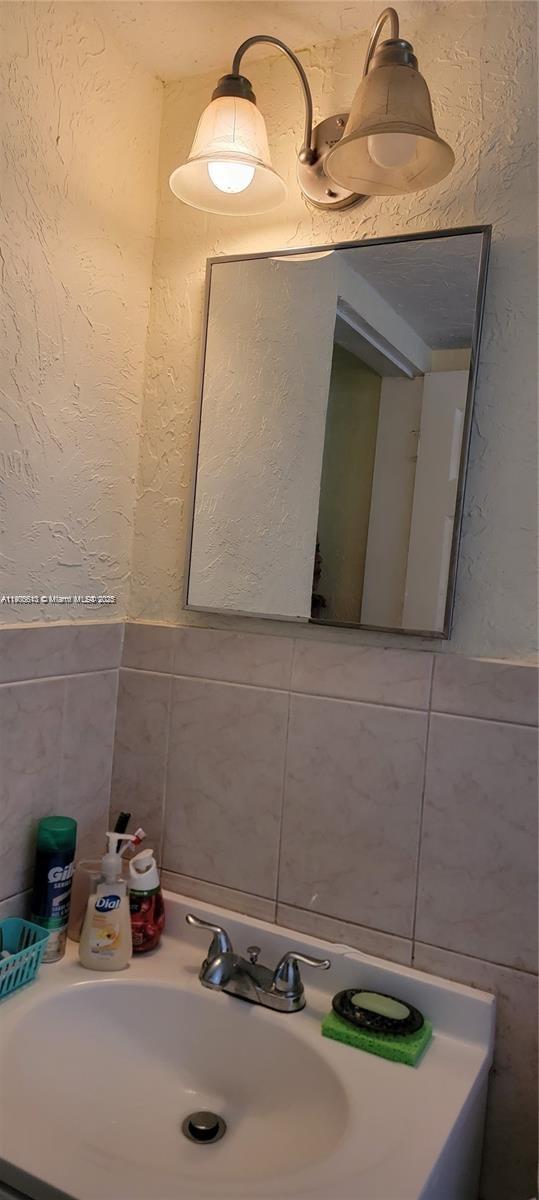 2441 Southwest 27th Avenue, Unit 1 Miami, FL 33145 - Photo 4 of 8 a bathroom with a sink and a mirror