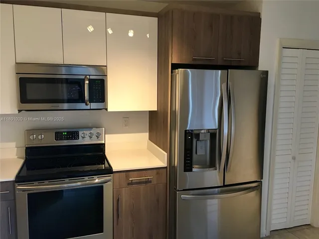 a kitchen with a refrigerator stove and microwave