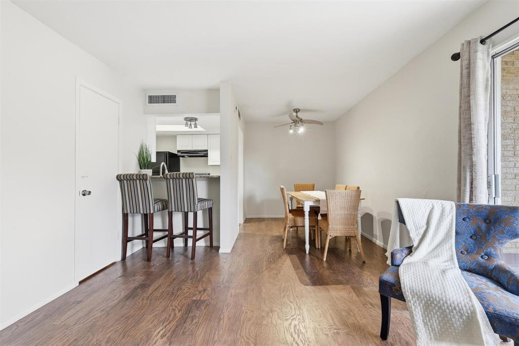 12818 Midway Road, Unit 2078 Dallas, TX 75244 - Photo 1 of 26 a view of a dining room with furniture and wooden floor