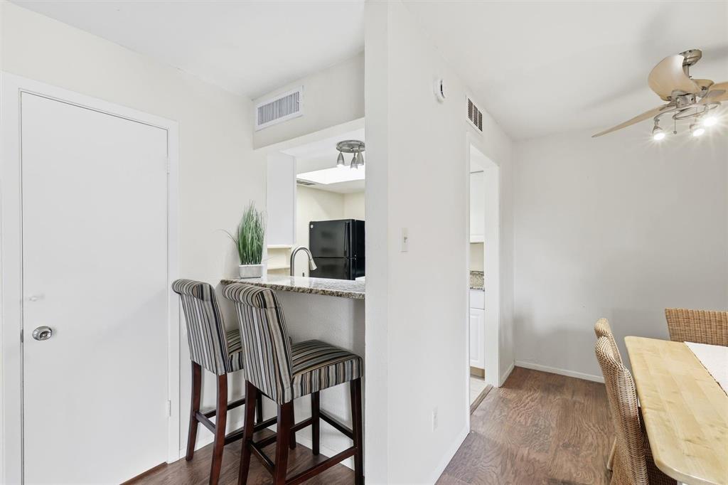 12818 Midway Road, Unit 2078 Dallas, TX 75244 - Photo 11 of 26 a view of a dining room with furniture and wooden floor