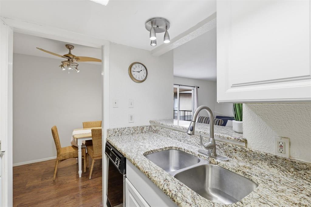 12818 Midway Road, Unit 2078 Dallas, TX 75244 - Photo 16 of 26 a kitchen with a stove a sink and a refrigerator with wooden floor