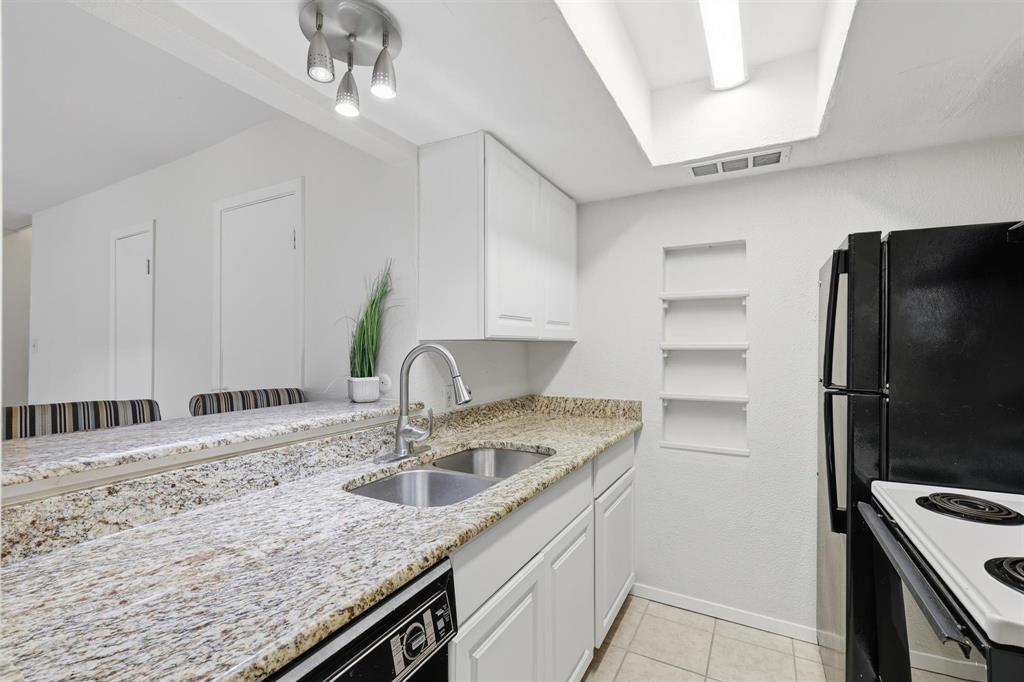 12818 Midway Road, Unit 2078 Dallas, TX 75244 - Photo 17 of 26 a kitchen with stainless steel appliances granite countertop a sink stove and refrigerator