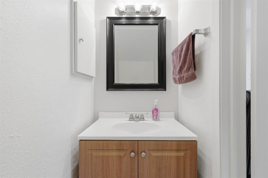 12818 Midway Road, Unit 2078 Dallas, TX 75244 - Photo 18 of 26 a bathroom with a sink and a mirror