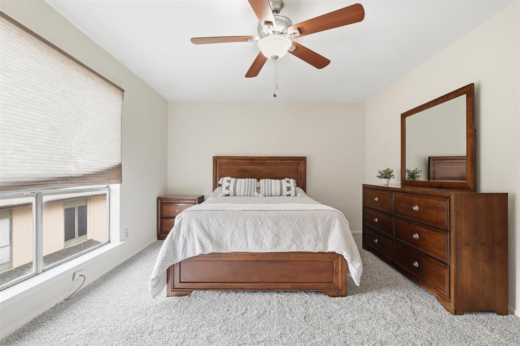 12818 Midway Road, Unit 2078 Dallas, TX 75244 - Photo 19 of 26 a bedroom with a bed and a dresser