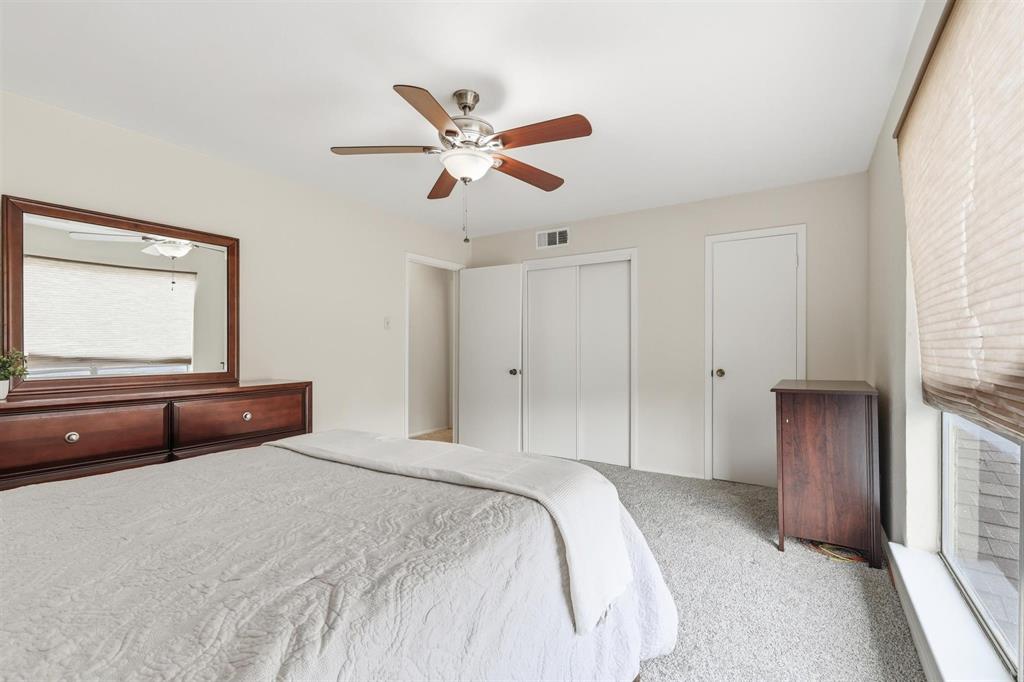 12818 Midway Road, Unit 2078 Dallas, TX 75244 - Photo 20 of 26 a bedroom with a large bed and a chandelier
