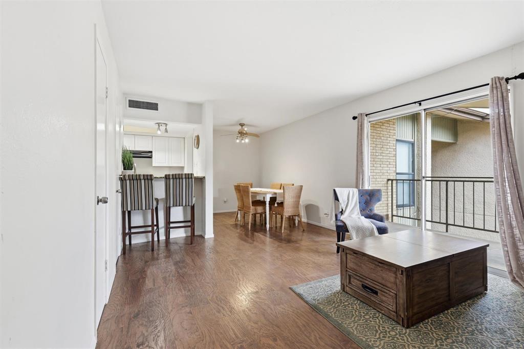 12818 Midway Road, Unit 2078 Dallas, TX 75244 - Photo 2 of 26 a living room with chairs wooden floor and a large window