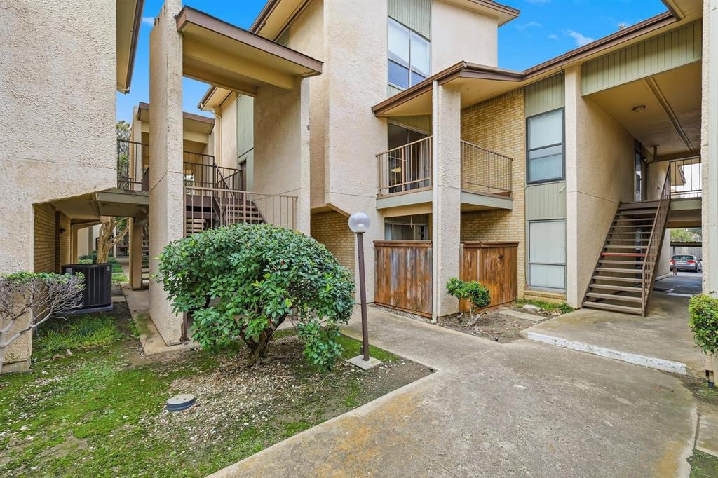 12818 Midway Road, Unit 2078 Dallas, TX 75244 - Photo 5 of 26 a view of a house with many windows next to a yard