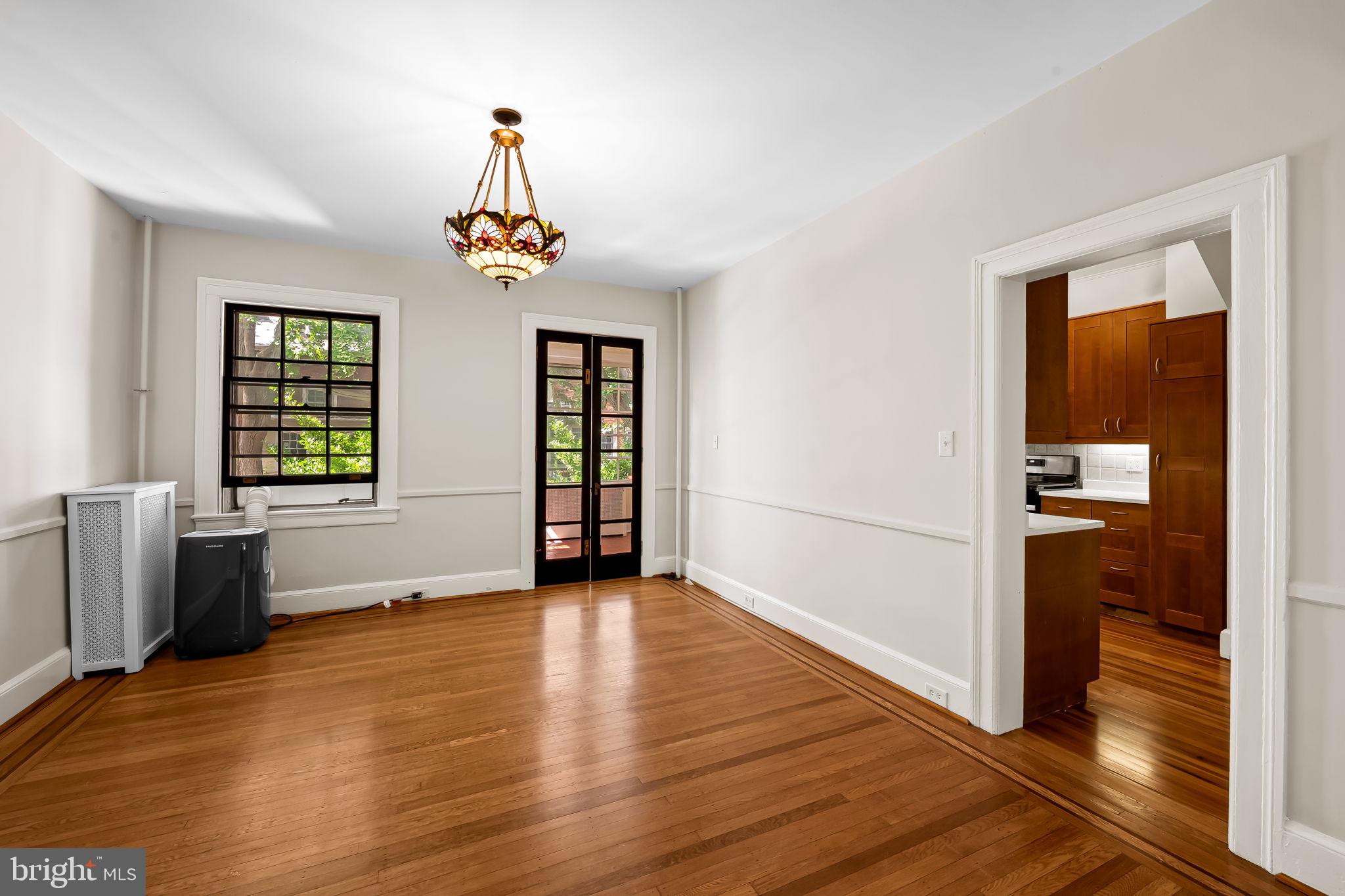 3916 Cloverhill Road Baltimore, MD 21218 - Photo 11 of 47 a view of an empty room with window and wooden floor