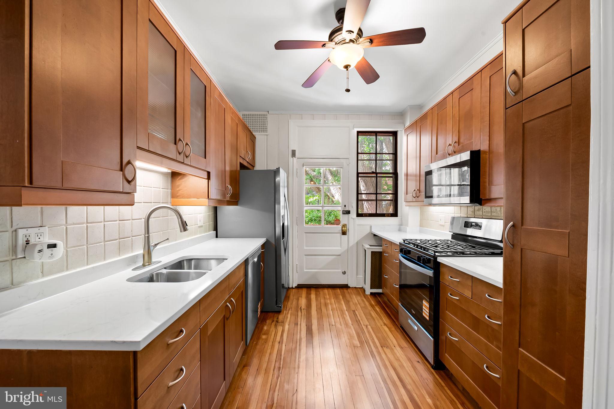 3916 Cloverhill Road Baltimore, MD 21218 - Photo 13 of 47 a kitchen with stainless steel appliances granite countertop a sink stove and refrigerator