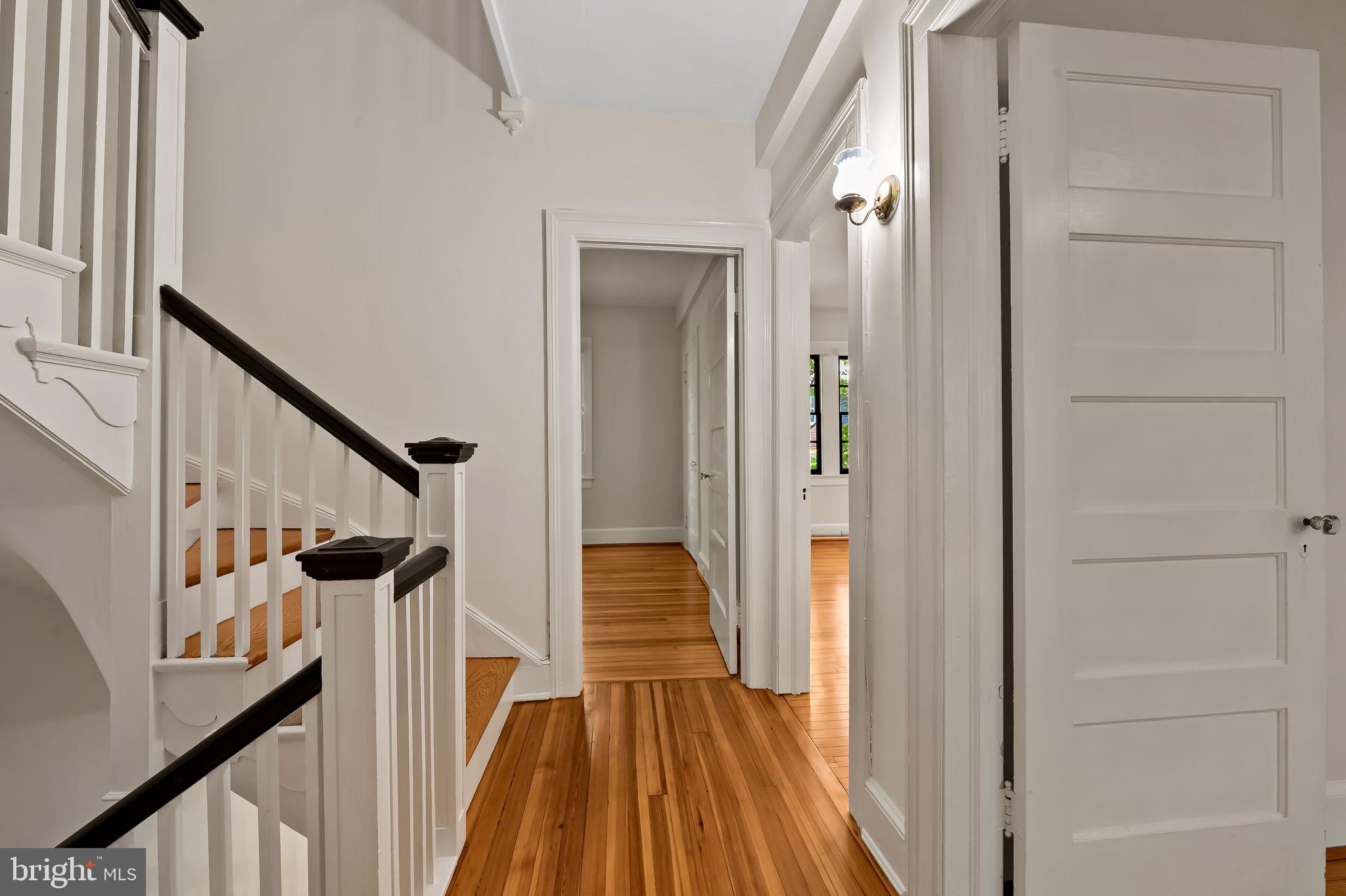 3916 Cloverhill Road Baltimore, MD 21218 - Photo 20 of 47 a view of a hallway with wooden floor and staircase