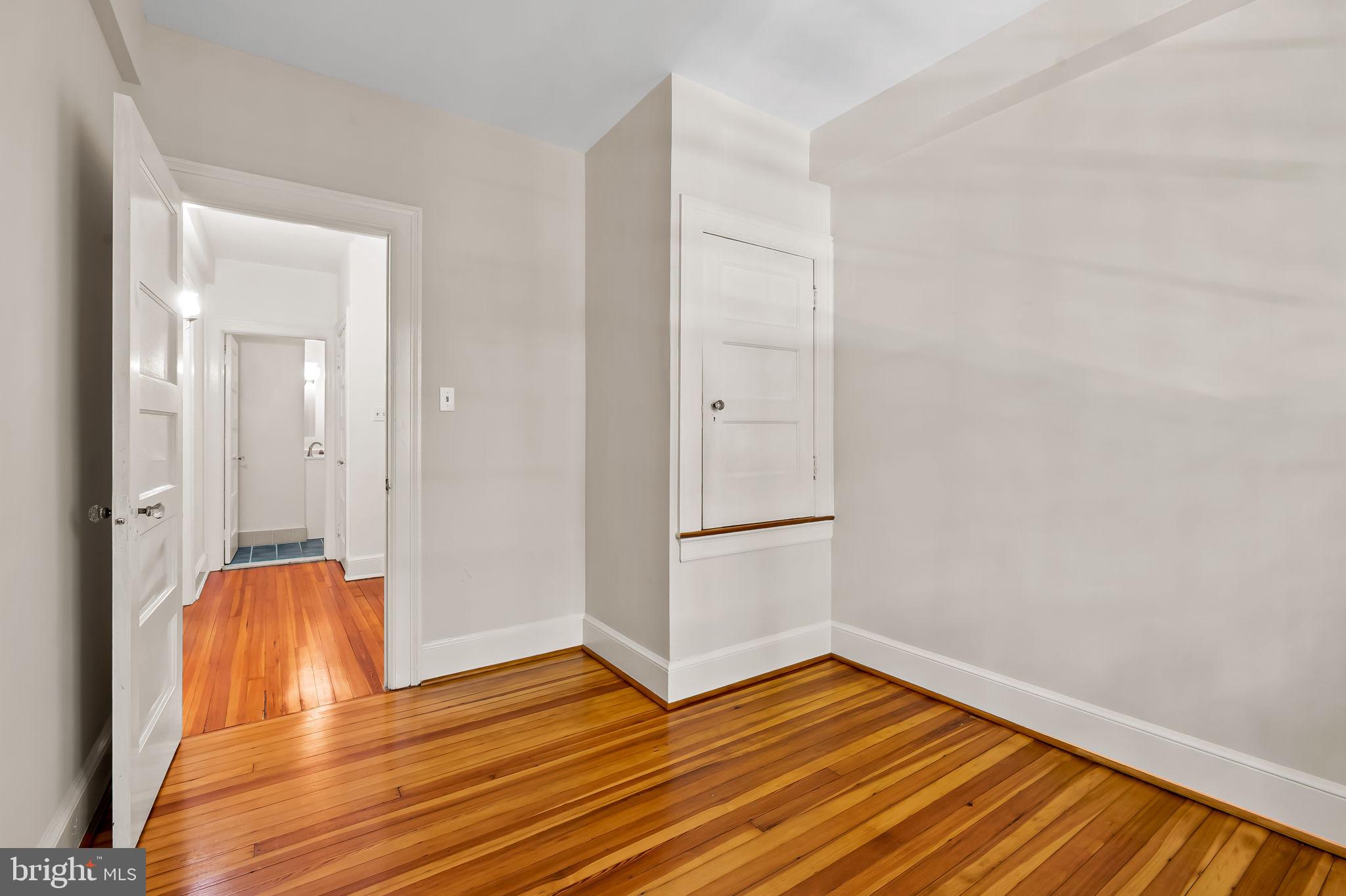 3916 Cloverhill Road Baltimore, MD 21218 - Photo 22 of 47 a view of empty room with wooden floor