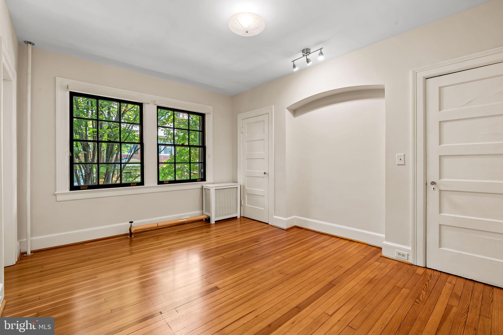 3916 Cloverhill Road Baltimore, MD 21218 - Photo 23 of 47 a view of an empty room with wooden floor and a window
