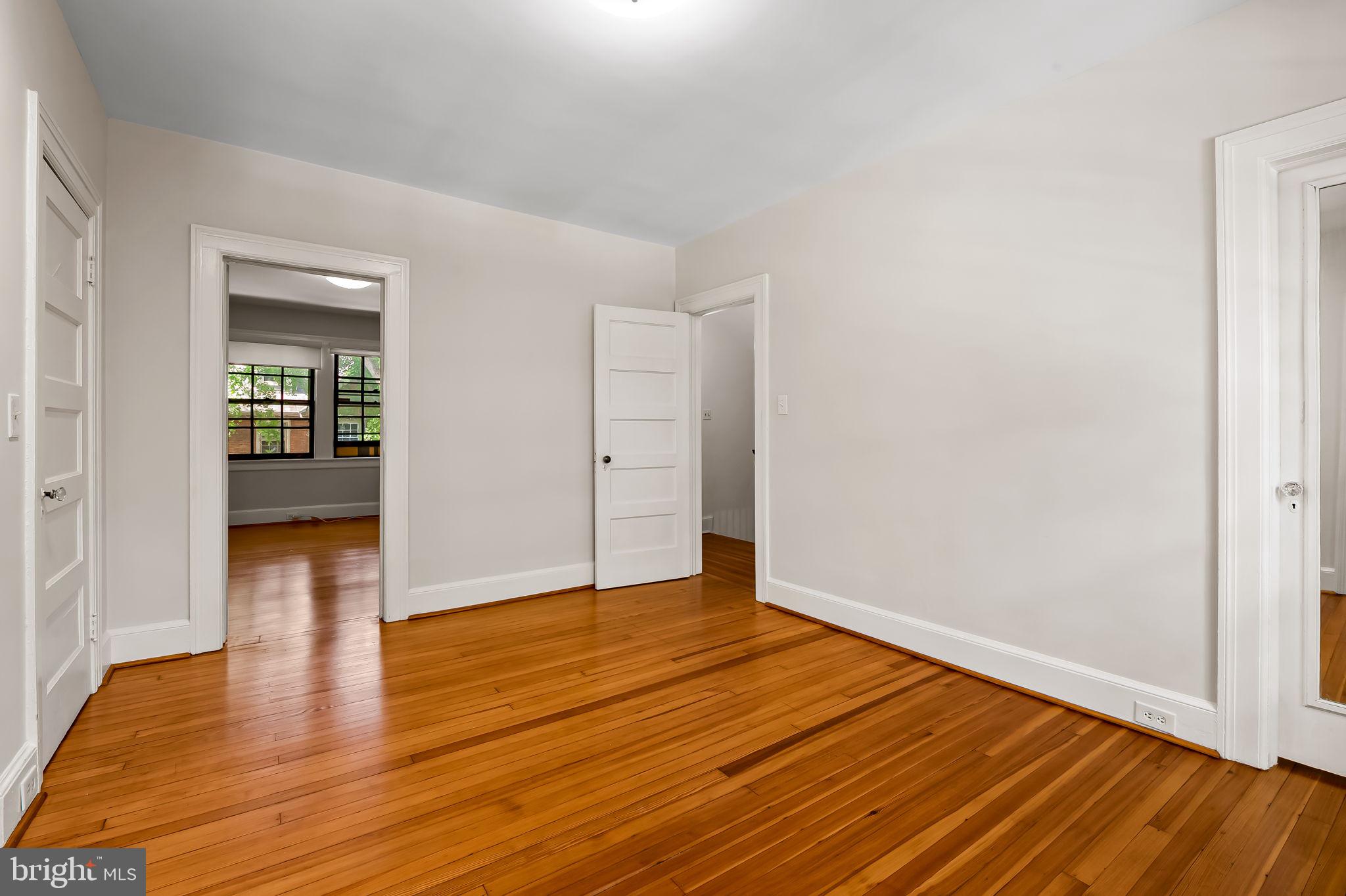 3916 Cloverhill Road Baltimore, MD 21218 - Photo 24 of 47 a view of an empty room with wooden floor