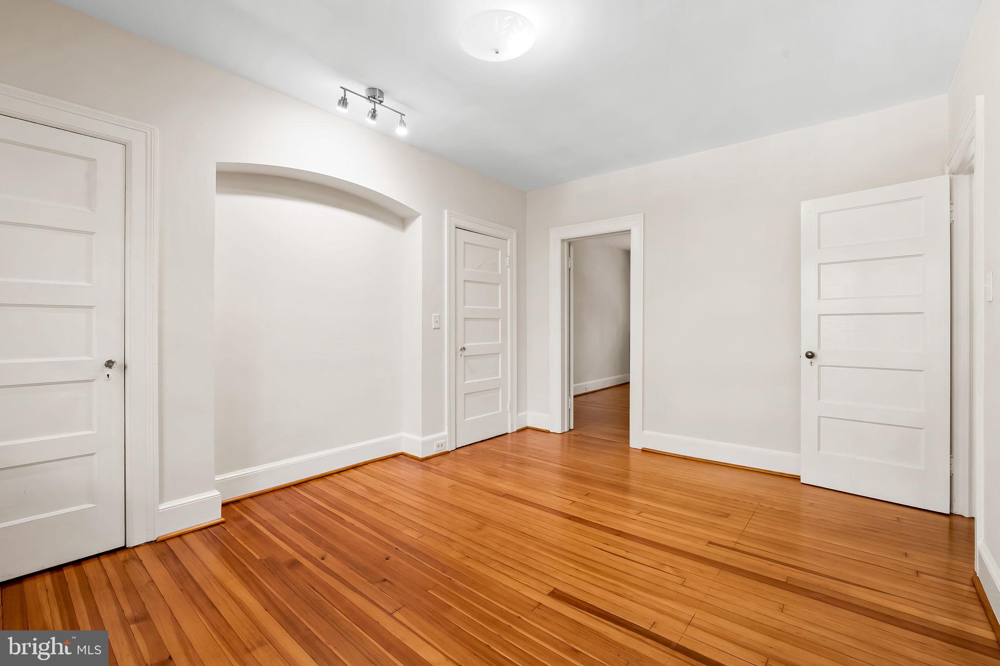 3916 Cloverhill Road Baltimore, MD 21218 - Photo 25 of 47 a view of an empty room with wooden floor