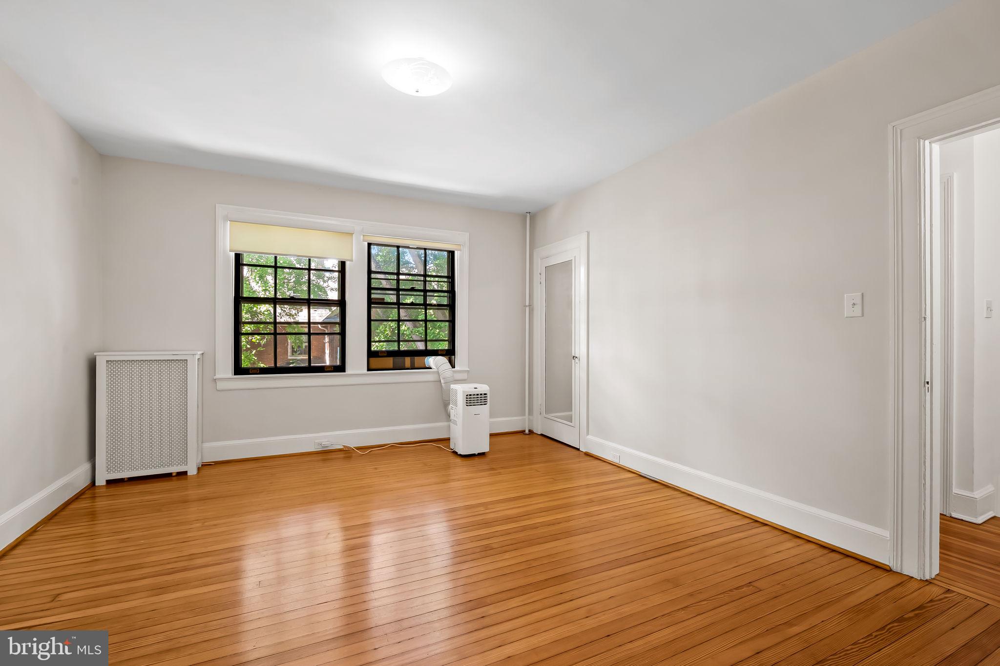 3916 Cloverhill Road Baltimore, MD 21218 - Photo 26 of 47 a view of an empty room with wooden floor and a window