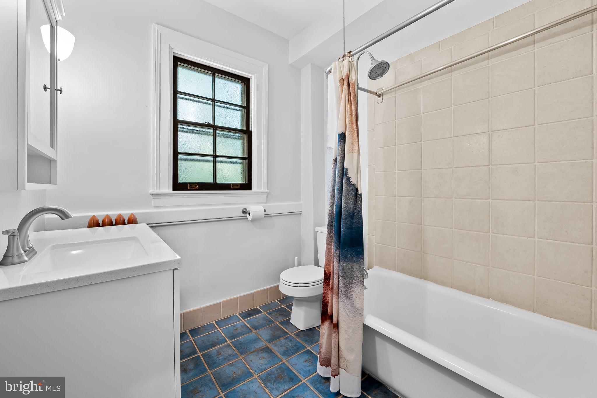 3916 Cloverhill Road Baltimore, MD 21218 - Photo 28 of 47 a bathroom with a sink toilet and shower