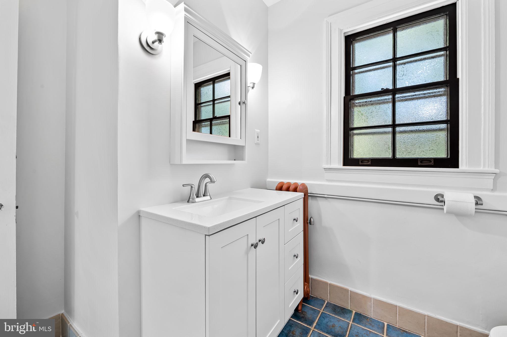 3916 Cloverhill Road Baltimore, MD 21218 - Photo 29 of 47 a bathroom with a sink and a window
