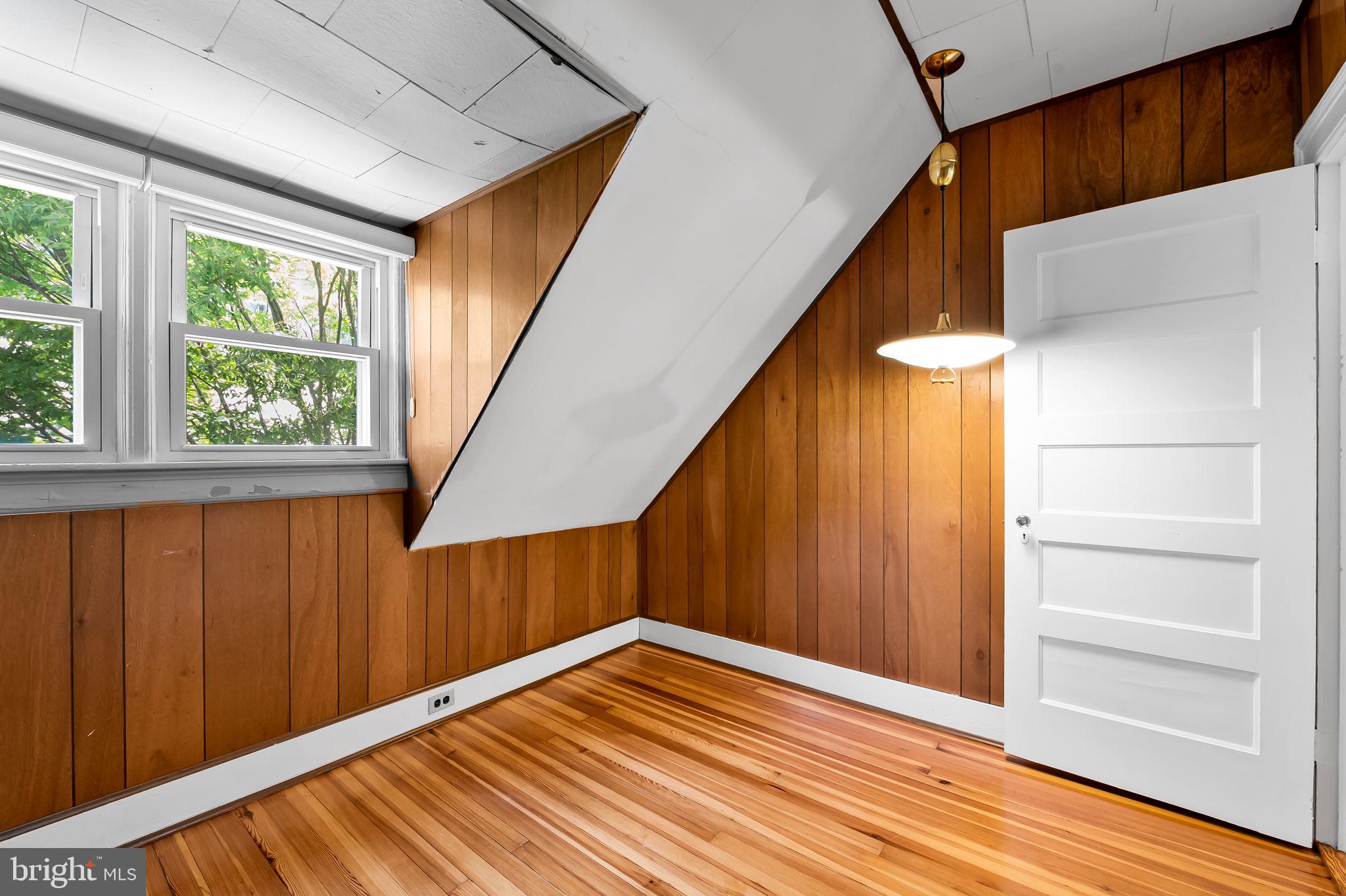 3916 Cloverhill Road Baltimore, MD 21218 - Photo 31 of 47 a view of an empty room with wooden floor and stairs