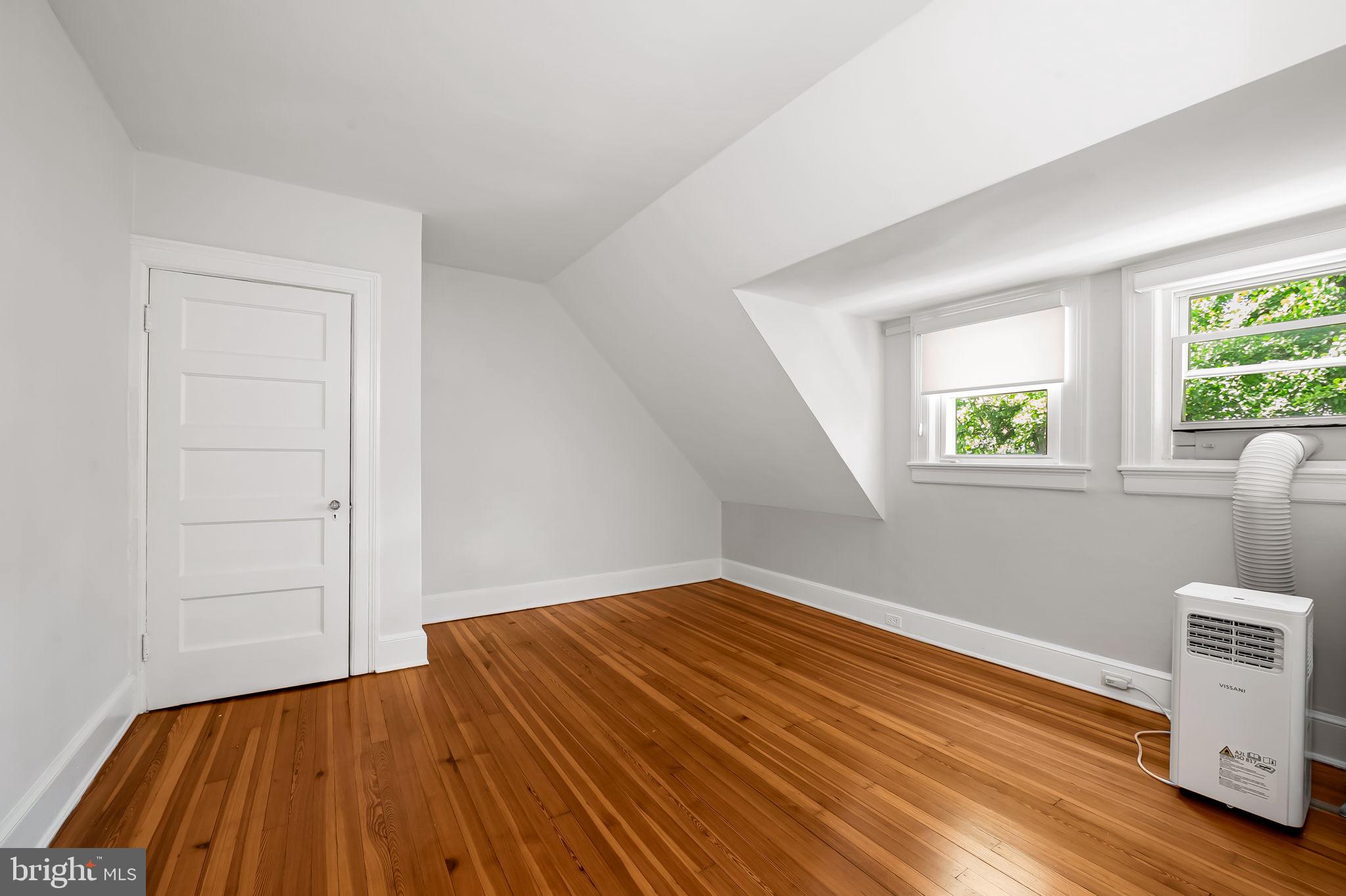3916 Cloverhill Road Baltimore, MD 21218 - Photo 34 of 47 wooden floor in an empty room with a window