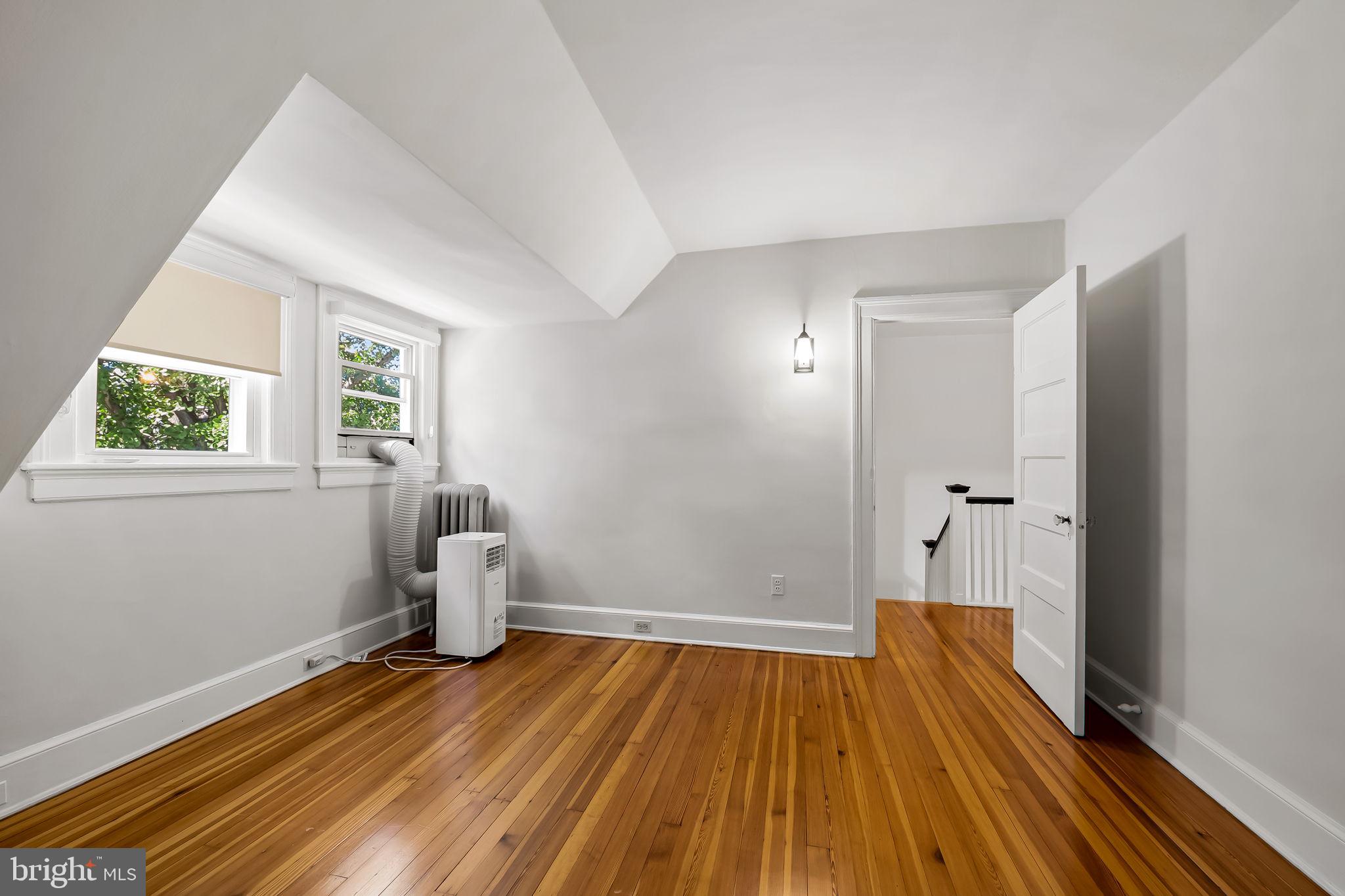 3916 Cloverhill Road Baltimore, MD 21218 - Photo 35 of 47 an empty room with wooden floor and windows
